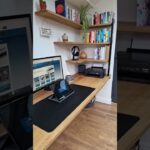 Custom oak table and floating shelves for this home office workspace.